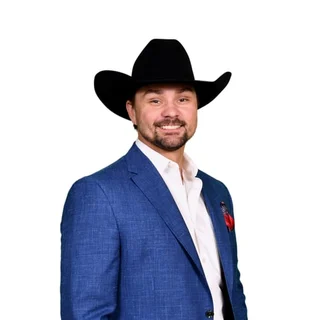Cole Caughern in a black cowboy hat and a blue blazer